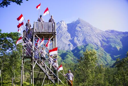 Young People with Flag. Indonesia Flag, Indonesia Independance Day with mt Merapi backgroundのeditorial素材
