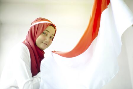 Asian Girl Kissing Indonesian flag, Indonesia independence dayの写真素材