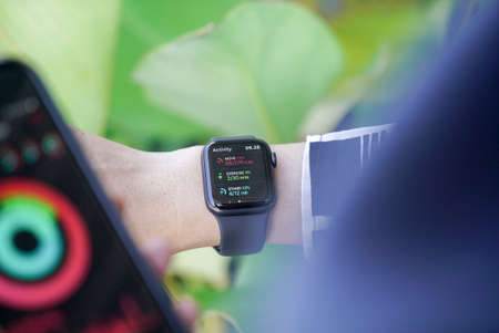 Bali Indonesia June 2, 2020 : Close up hand monitoring Heart Rate on smart watch with keyboard...