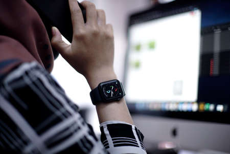 Bali Indonesia June 2, 2020 : Woman using smart watch in calling on the phoneのeditorial素材