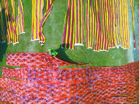 Colorful Batik hanging to dry after drawing batik  process