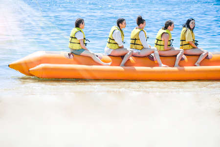 Bali Indonesia June 24, 2020 : Groub of people ride Banana boat sunlight morning in Tanjung Benoa Baliのeditorial素材