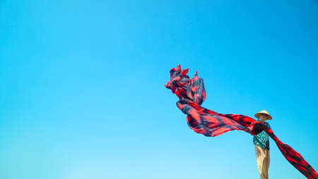 Indonesia June 20, 2020 : Batik hanging along blue sky background. make for colorful souvenirs of Bali, Hanging Fabric Backgroundのeditorial素材