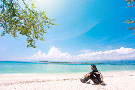 Isolated tropical island with white sandy beach and blue transparent waterのeditorial素材