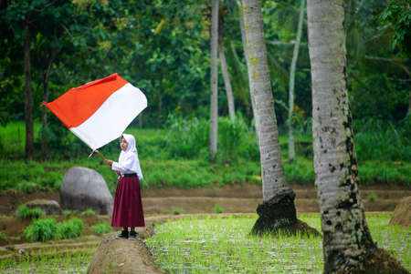 Bali Indonesia 17 August 2020 : Student flapper Indonesian flag, Indonesia independence day celebration conceptのeditorial素材