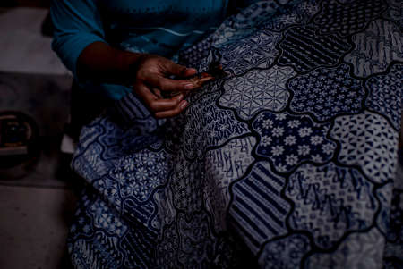 Indonesia June 18, 2020 : Batik, Close Up hand and canting, making Batik Tulis Indonesia. Canting is...