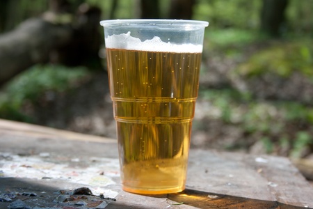 The glass of beer on the table in the natureの写真素材