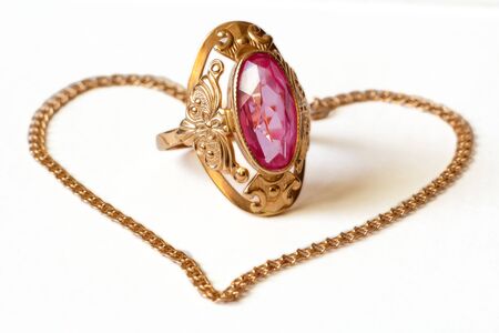 golden ring with amethyst and bracelet on white backgroundの写真素材