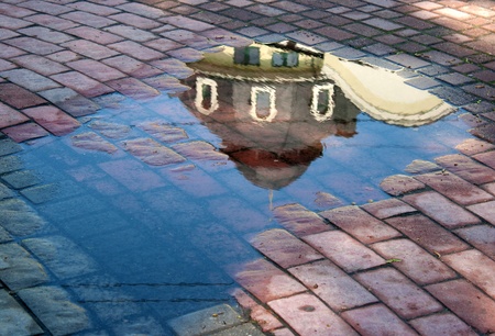 reflection building in the puddle after rain on summerの写真素材