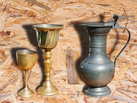 metal pitcher and two goblets on the table outdoorの写真素材