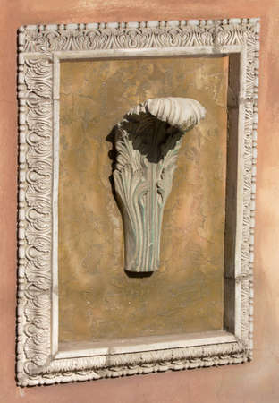 old abstract decorative bas-relief on the wall outdoor in city street