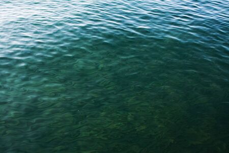 green waves on the lake on summer as textureの写真素材