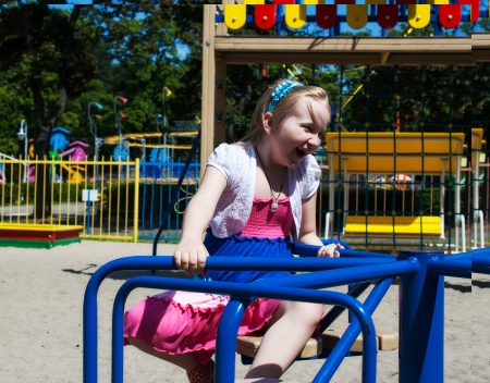 girl riding on a carousel in the parkの写真素材