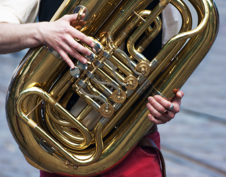 hands of a musician playing a heliconの写真素材