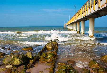 metal pier stretching into the sea on sunny spring dayの写真素材