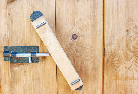 wooden handle on a wooden door with metal latch closeupの写真素材