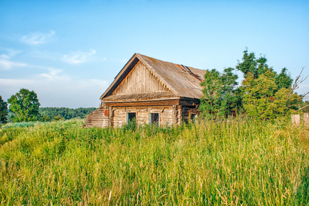 old abandoned wooden house on sunny summer dayの写真素材