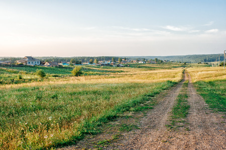 dirt country road on summer sunsetの写真素材