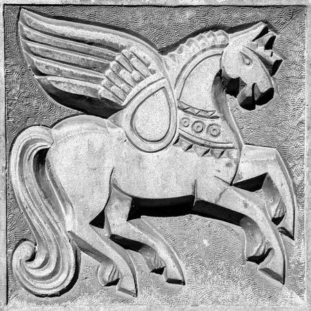 winged fairy horse, stone bas-relief on the wallの写真素材
