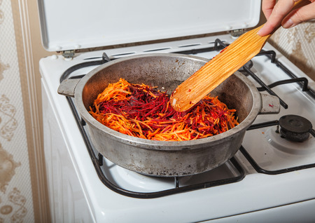 frying in a pan carrots and beets closeupの写真素材