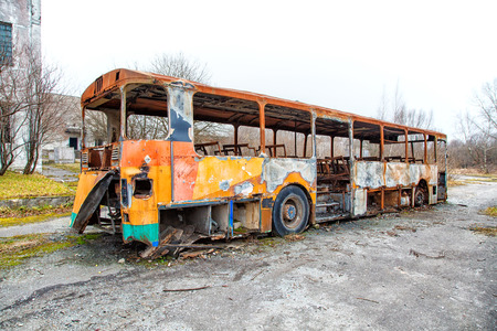 burned the abandoned bus on gloomy cold autumn dayの写真素材