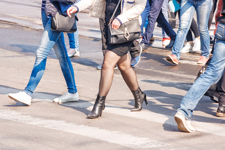 feet of the people going on the street on sunny spring dayの写真素材