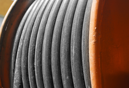large yellow metal coil with electric cable outdoor closeupの写真素材