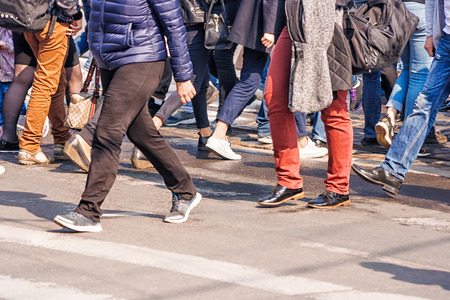 feet of the people going on the street on sunny spring dayの写真素材
