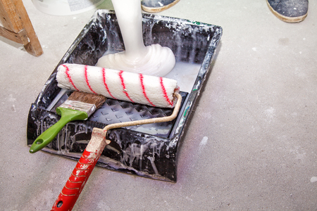 container with wallpaper glue standing on the floor in the room closeupの写真素材