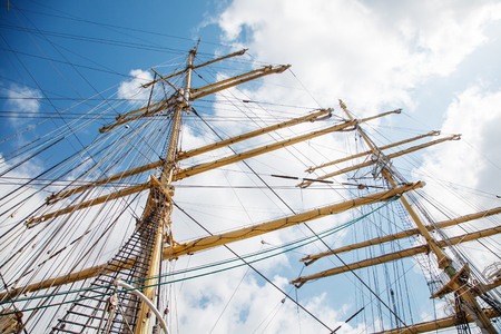 ship mast with rigging on the bright blue sky background