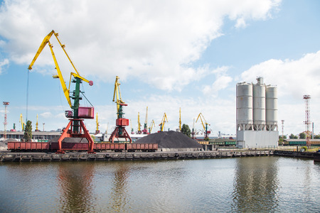 cranes for unloading wagons in the seaport on summer day