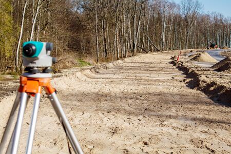 construction of a new modern road in the forest on sunny spring day