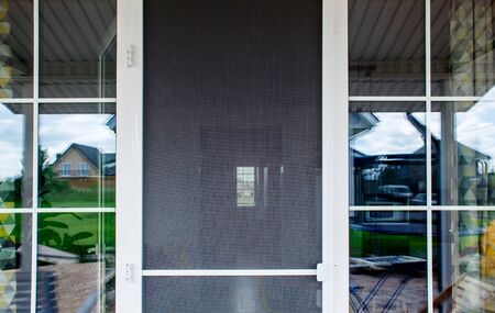 plastic door with mosquito net outdoor with daylightの写真素材
