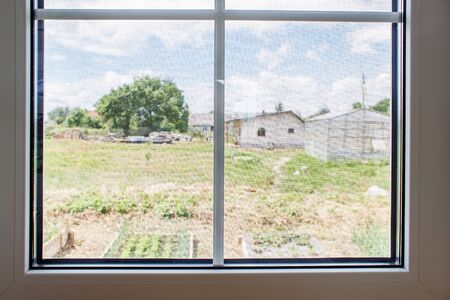 plastic window with mosquito net indoor closeup