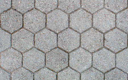 road paved with hexagonal sidewalk tiles. beautiful brick background with, masonry texture of light gray bricks. outdoor closeupの写真素材