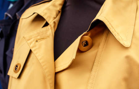 several women's coats worn on mannequins in the city market outdoor on autumn day