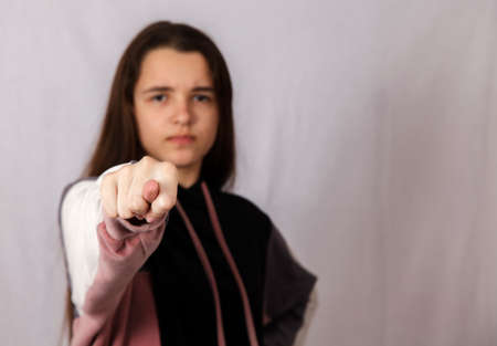 teen girl showing a fig in the studio. closeup indoor