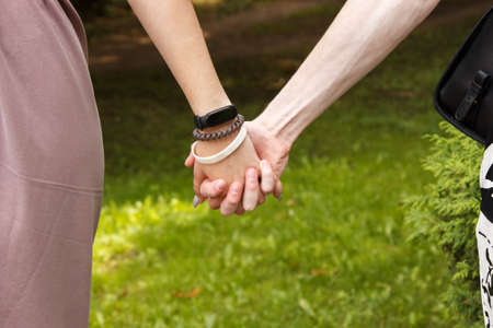 man and woman holding hands. hands closeup. outdoor on summer dayの写真素材