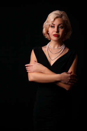 portrait of a young blonde woman in the studio on black backgroundの写真素材