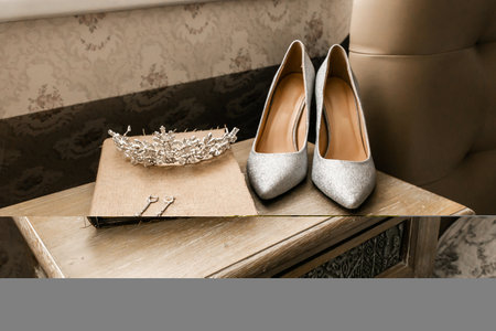 earrings, wreath and shoes for bride with old book on table indoor closeup. wedding set. wedding conceptの写真素材