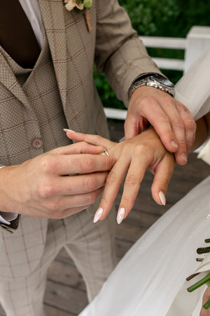 groom puts ring on bride's finger. hands closeup. wedding conceptの写真素材