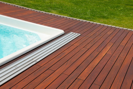 Swimming pool with teakwood flooring stripes summer vacation, teak wood deckingの写真素材
