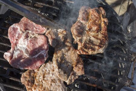 Barbecue stuff grills bacon, pork chop. Delicious toasted traces and smoke. Top viewの写真素材