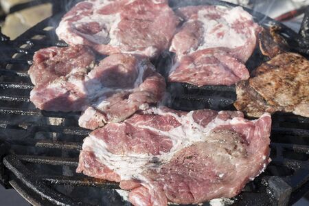 Grilling bacon, raw pork chops with delicious toasted traces. Smoke. Close up viewの写真素材