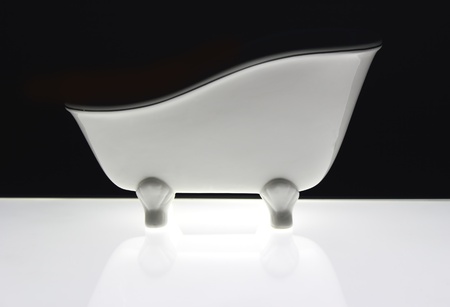 white bath old fashion style on black background with flourescent lightの写真素材