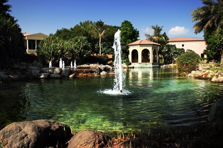luxury house with fountains in the garden and palm treesのeditorial素材