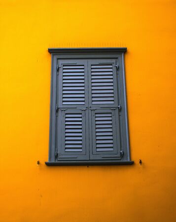window on yelow wall
