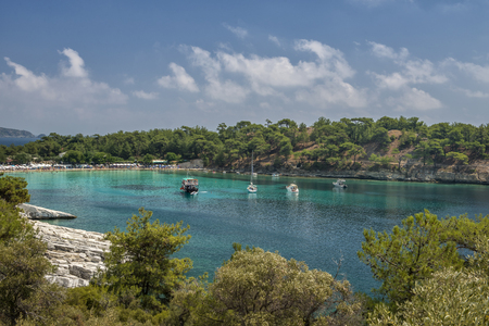 yachts in the seashore island with people swiming in turqoase water, panoramic view の写真素材