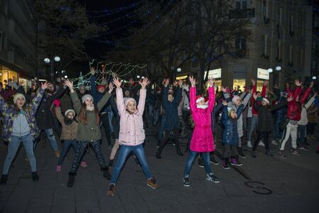 Burgas, Bulgaria - December 23, 2017: Happy kids with families on flashmob days before christmas and new year's dayのeditorial素材
