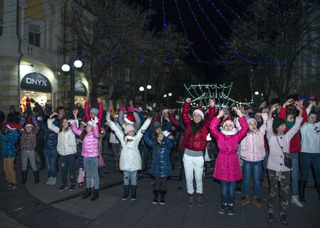Burgas, Bulgaria - December 23, 2017: Happy kids with families on flashmob days before christmas and new year's dayのeditorial素材